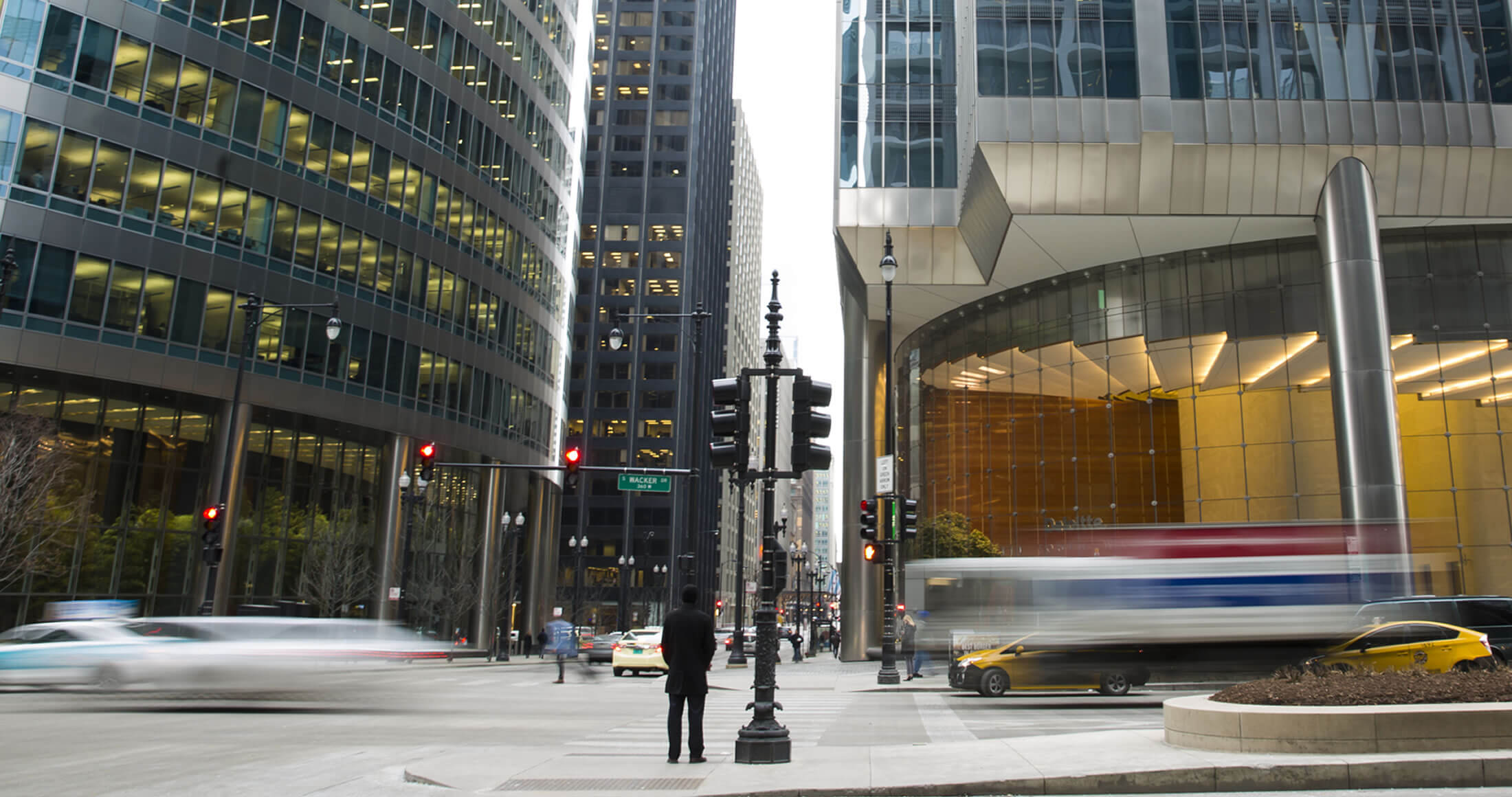 Man standing still with traffic moving around him